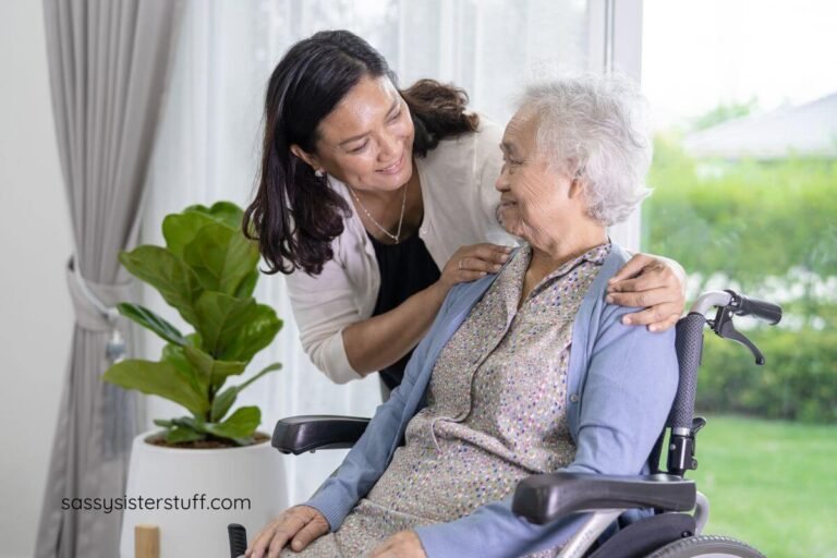 an adult daughter hugs her senior mother who is sitting in a wheel chair at her senior living facility.