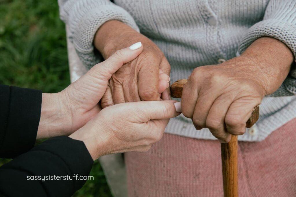 close-up of caregiver and her loved one holding hands