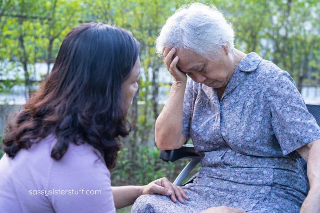 adult daughter comforting her elderly mothers.