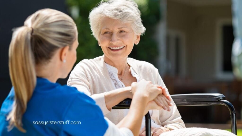 a nursing home nurse takes a patient outside for some fresh air and sits with her.