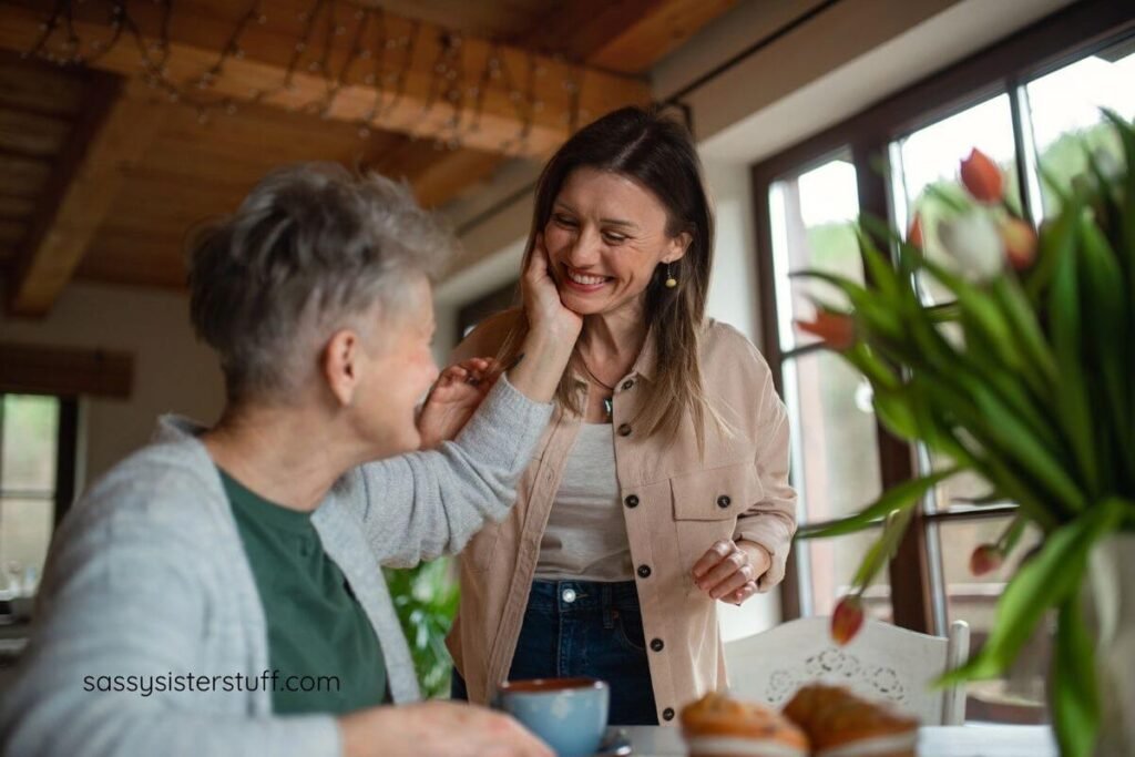 senior mother touches her adult daughter's check because she is appreciative of her help.