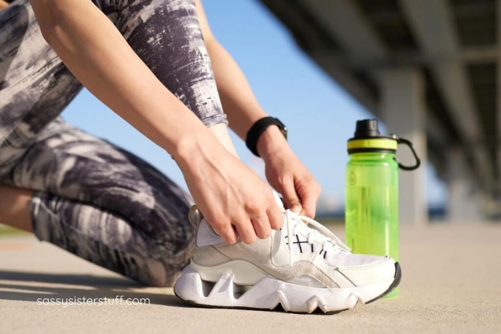 close up of a female putting on sneakers.