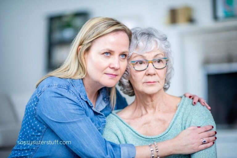 a middle aged woman hugs her elderly mom.