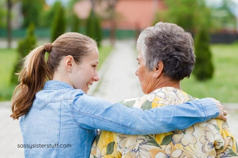 elderly mom and adult daughter walking together and talking.