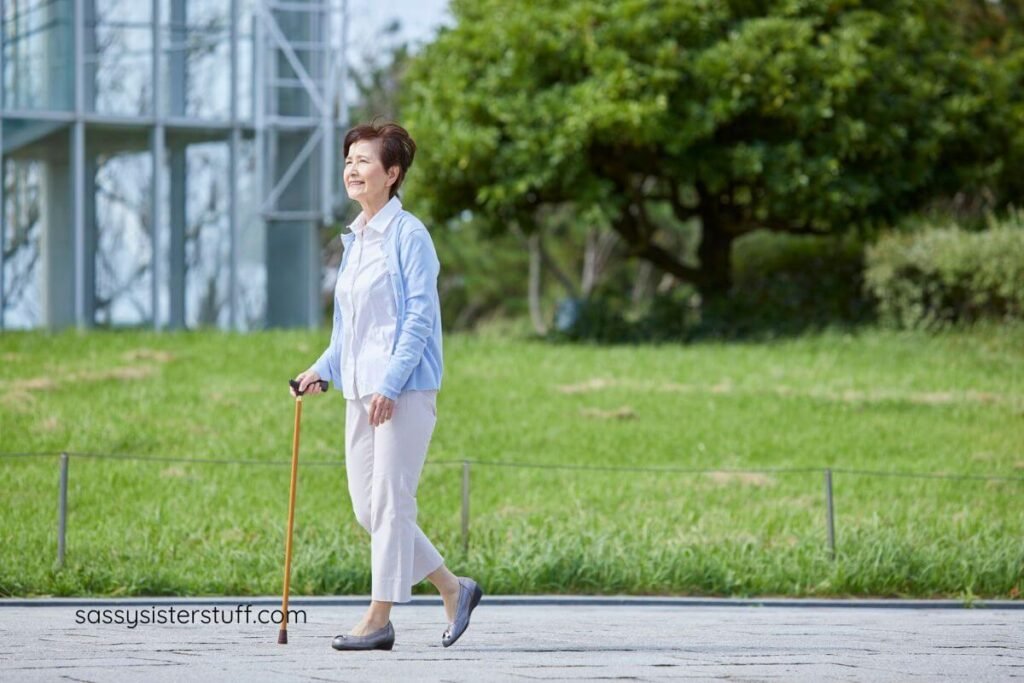 aging woman using a cane to take a walk.