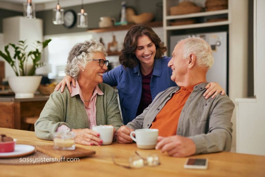 loving adult daughter with her arms around the shoulders of her elderly parents.