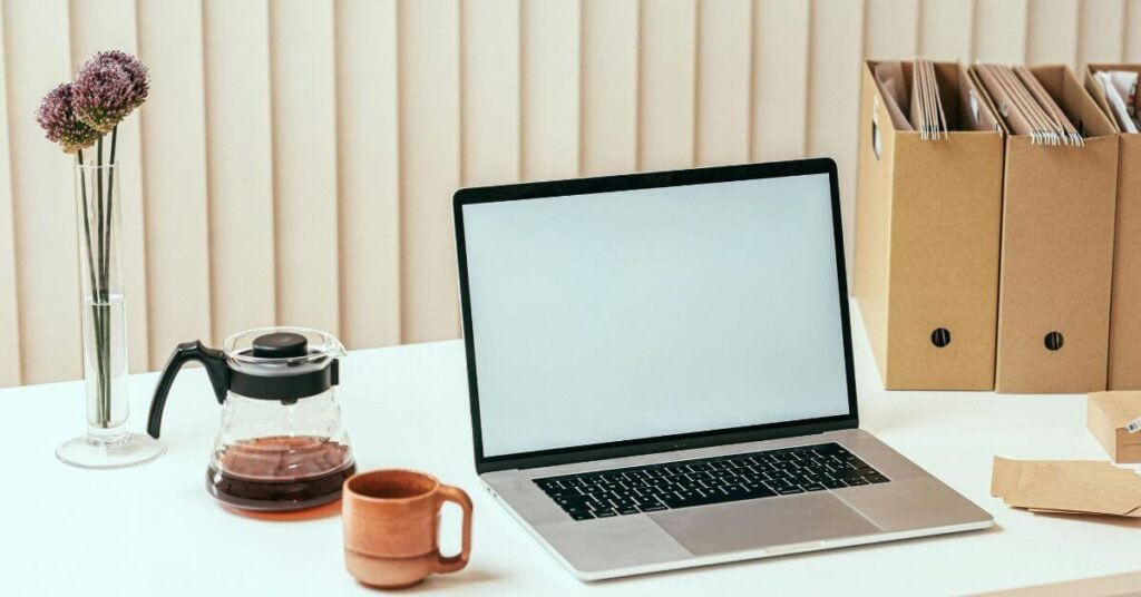 simple home command center for caregivers with laptop and file boxes on a flat surface;