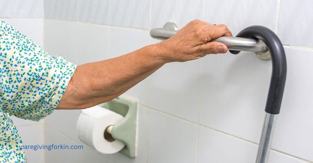 safety bar on the wall in a bathroom and an older woman has her hand on it with a cane hanging over it.