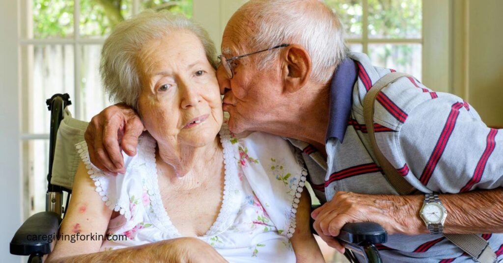 an elderly husband gives his ailing wife a kiss because evenings can be hard for people with dementia.